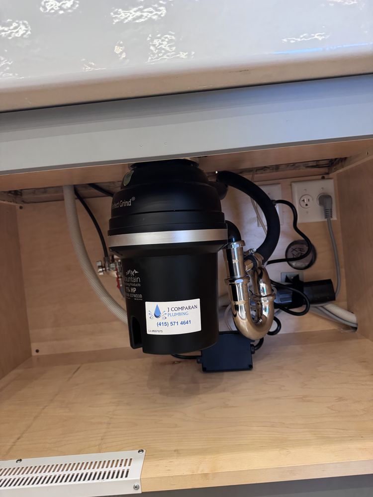 Garbage disposal unit installed underneath a kitchen sink